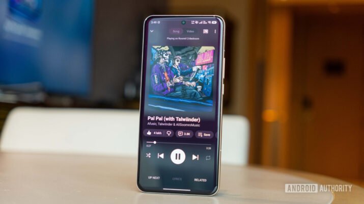 Tampilan layar smartphone yang menunjukkan aplikasi YouTube Music dengan lirik lagu yang diblur dan pesan notifikasi untuk berlangganan Premium.